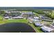 Expansive aerial view of the community featuring a lake, clubhouse, pool, and golf course at 14724 Cherry Blossom Way, Punta Gorda, FL 33955
