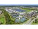 Community aerial showcasing a tennis courts, clubhouse, pool, and beautiful lakes amidst lush landscape at 14724 Cherry Blossom Way, Punta Gorda, FL 33955