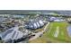 Aerial view of the clubhouse, swimming pool, and amenities with beautiful golf course at 14724 Cherry Blossom Way, Punta Gorda, FL 33955
