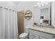 Bathroom features a granite vanity, toilet, and a shower with a towel rack at 14724 Cherry Blossom Way, Punta Gorda, FL 33955