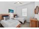 Bright bedroom features two twin beds, a ceiling fan, and carpeted flooring at 14724 Cherry Blossom Way, Punta Gorda, FL 33955