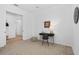 Bedroom features carpet flooring, a desk and chair, and a light fixture at 14724 Cherry Blossom Way, Punta Gorda, FL 33955