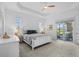 Bedroom with large windows, neutral carpet, and access to the outdoor lanai at 14724 Cherry Blossom Way, Punta Gorda, FL 33955