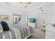 Bedroom featuring a ceiling fan, trey ceiling, and a view of the outdoor patio at 14724 Cherry Blossom Way, Punta Gorda, FL 33955