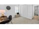 Bedroom with a desk and chair, closet, and a clock on the wall at 14724 Cherry Blossom Way, Punta Gorda, FL 33955