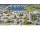 This aerial showcases the community clubhouse, parking, and lush landscaping at 14724 Cherry Blossom Way, Punta Gorda, FL 33955