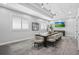 Modern conference room featuring a large table, comfortable chairs, and a wall-mounted TV at 14724 Cherry Blossom Way, Punta Gorda, FL 33955