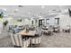 Cozy dining area has multiple tables and chairs for residents and guests at 14724 Cherry Blossom Way, Punta Gorda, FL 33955