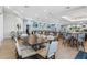 Inviting dining area features stylish tables and chairs, with a bar area visible in the background at 14724 Cherry Blossom Way, Punta Gorda, FL 33955