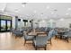 A well-lit community dining room with tables, chairs, and large windows at 14724 Cherry Blossom Way, Punta Gorda, FL 33955