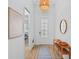 Bright foyer with light-colored walls, wood-look floors, and decorative lighting at 14724 Cherry Blossom Way, Punta Gorda, FL 33955