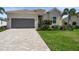 Charming single-story home featuring a tile roof, paved driveway, and well-manicured landscaping at 14724 Cherry Blossom Way, Punta Gorda, FL 33955