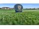 Golf course marker with the letter H on a green and blue background at 14724 Cherry Blossom Way, Punta Gorda, FL 33955