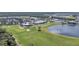 Aerial shot of the golf course with a pond and houses at 14724 Cherry Blossom Way, Punta Gorda, FL 33955