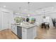 Kitchen island offering seating and seamlessly connecting to the living and dining areas at 14724 Cherry Blossom Way, Punta Gorda, FL 33955