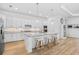Bright kitchen features an island with seating, granite countertops, and stainless steel appliances at 14724 Cherry Blossom Way, Punta Gorda, FL 33955