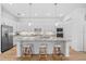 Open kitchen with a center island, pendant lighting, and stainless steel appliances at 14724 Cherry Blossom Way, Punta Gorda, FL 33955