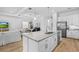 Spacious kitchen island with stainless steel appliances and a view into the living room at 14724 Cherry Blossom Way, Punta Gorda, FL 33955