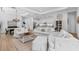 Bright living room with neutral furniture and open concept design, seamlessly connecting to kitchen at 14724 Cherry Blossom Way, Punta Gorda, FL 33955