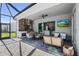 Wide view of the covered outdoor living and entertaining space including a kitchen, dining, and lounge area at 14724 Cherry Blossom Way, Punta Gorda, FL 33955