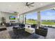 Stylish outdoor lounge offers comfortable seating, a fireplace, and beautiful views of the lake and community at 14724 Cherry Blossom Way, Punta Gorda, FL 33955