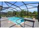 Screened-in pool and spa with nearby lounge chairs are perfect for relaxation and enjoyment at 14724 Cherry Blossom Way, Punta Gorda, FL 33955
