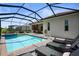 Screened-in pool and spa and a covered outdoor living space, perfect for outdoor relaxation and entertaining at 14724 Cherry Blossom Way, Punta Gorda, FL 33955