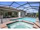 Outdoor pool and spa area with covered patio including an outdoor kitchen and dining area at 14724 Cherry Blossom Way, Punta Gorda, FL 33955