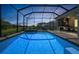 The screened pool and spa are bathed in the fading light of sunset at 14724 Cherry Blossom Way, Punta Gorda, FL 33955