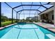 Lovely screened pool and spa area with paver deck and lush landscaping overlooking the greenery at 14724 Cherry Blossom Way, Punta Gorda, FL 33955