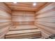 Warm wooden sauna with built-in benches for relaxation and therapeutic benefits at 14724 Cherry Blossom Way, Punta Gorda, FL 33955