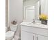 The half bathroom has a modern sink, light fixtures, and elegant decor at 16408 Bridle Ridge St, Port Charlotte, FL 33953