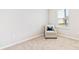 Cozy bedroom featuring neutral carpet and a comfortable armchair by a window at 16408 Bridle Ridge St, Port Charlotte, FL 33953