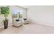 Well-lit bedroom with neutral walls, plush carpeting, and two armchairs by a large window at 16408 Bridle Ridge St, Port Charlotte, FL 33953