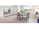 Stylish dining room with modern table setting, view into the office area, and abundant natural light at 16408 Bridle Ridge St, Port Charlotte, FL 33953