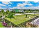 Aerial shot of a fenced community dog park with lush grass, shaded areas and walking path, with parking area nearby at 16408 Bridle Ridge St, Port Charlotte, FL 33953