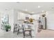 Modern kitchen with white cabinets, stainless steel appliances, and a breakfast bar with seating at 16408 Bridle Ridge St, Port Charlotte, FL 33953