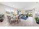 Bright open-concept living space featuring dining area, living room, and sliding door access to the outdoors at 16408 Bridle Ridge St, Port Charlotte, FL 33953