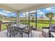 This screened patio has a dining table for six and peaceful nature views at 16408 Bridle Ridge St, Port Charlotte, FL 33953