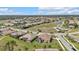 Expansive aerial view of a residential community, featuring well-maintained homes, lush landscaping, and tranquil ponds at 1715 Queen Palm Way, North Port, FL 34288
