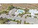 Aerial shot showcasing the community pool with ample parking, lush landscaping, and nearby amenities at 1715 Queen Palm Way, North Port, FL 34288