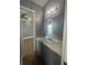 Bathroom vanity with marble countertop, grey cabinets, and a view into the bedroom at 2031 Basin St, Port Charlotte, FL 33952