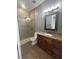 Bathroom with stylish walk-in shower, wood-look tile, and a granite vanity at 2031 Basin St, Port Charlotte, FL 33952