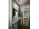 Bathroom with vanity viewed from bedroom doorway. Mirror reflects window at 2031 Basin St, Port Charlotte, FL 33952