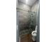 Updated bathroom shower with pebble floor, tile surround, and glass door at 2031 Basin St, Port Charlotte, FL 33952