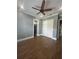 Neutral bedroom with wood-look tile, base trim, overhead fan, and double door closet at 2031 Basin St, Port Charlotte, FL 33952
