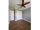 Bedroom featuring stylish wood-look tile flooring, neutral paint, and a double door closet at 2031 Basin St, Port Charlotte, FL 33952