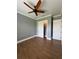 Bedroom with wood-look tile flooring, neutral paint, and double door closet with storage at 2031 Basin St, Port Charlotte, FL 33952