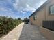 Home exterior featuring a brick-paved walkway and patio along the side of the house at 2031 Basin St, Port Charlotte, FL 33952