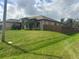 Landscaped property featuring a well-manicured lawn and a fenced-in backyard at 2031 Basin St, Port Charlotte, FL 33952